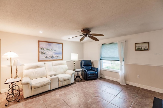 living room featuring a textured ceiling, ceiling fan, and tile patterned floors