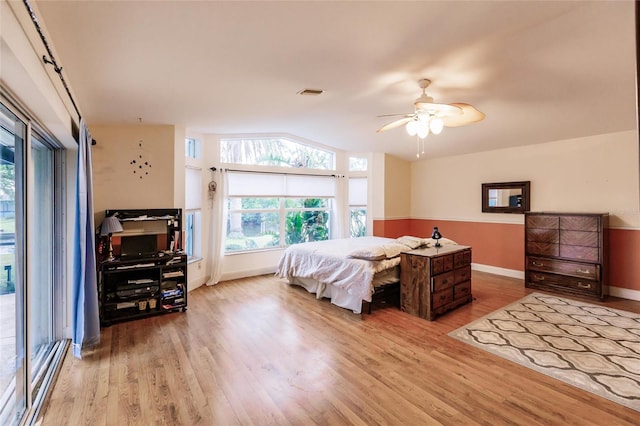 bedroom with light wood-type flooring, ceiling fan, and access to exterior