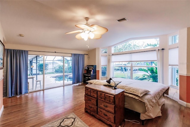 bedroom featuring light wood-type flooring, access to outside, multiple windows, and ceiling fan