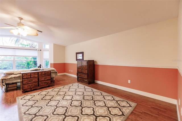 bedroom featuring light hardwood / wood-style floors, lofted ceiling, and ceiling fan