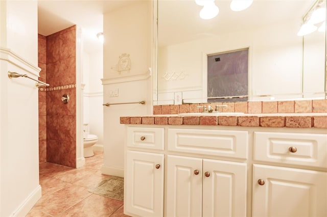 bathroom featuring toilet, vanity, and tile patterned floors