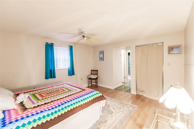 bedroom with ceiling fan, a closet, and light wood-type flooring