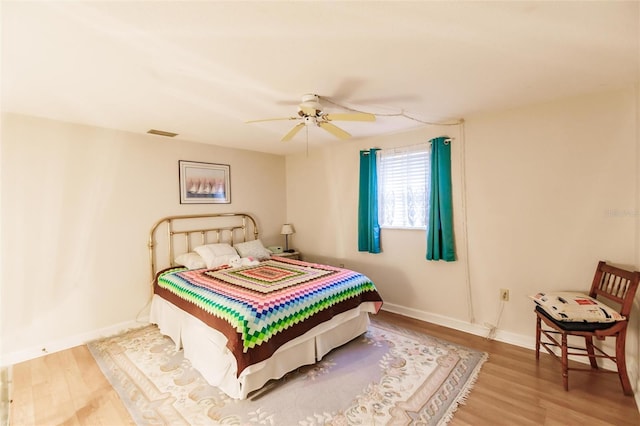 bedroom with hardwood / wood-style floors and ceiling fan