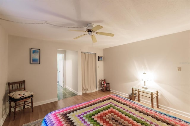 bedroom with ceiling fan and dark hardwood / wood-style flooring