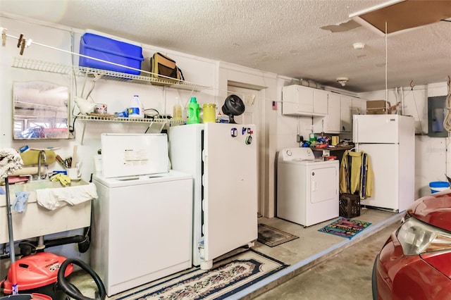 washroom featuring electric panel, a textured ceiling, and washer and dryer