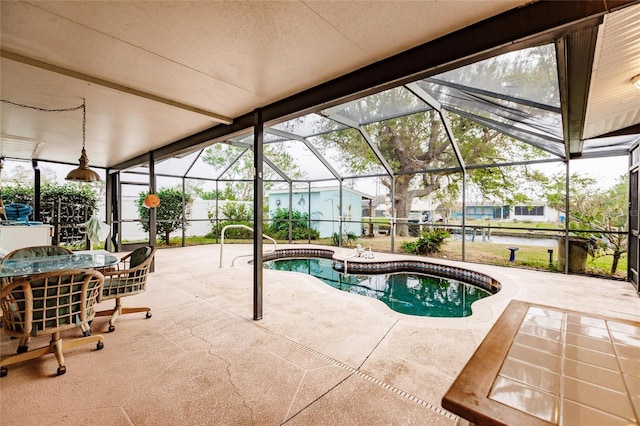 view of swimming pool featuring glass enclosure, a jacuzzi, and a patio