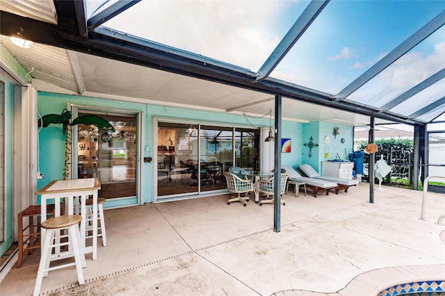 view of patio featuring a lanai