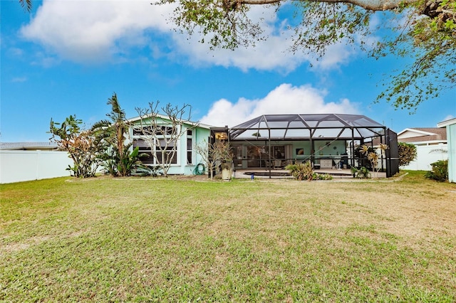 back of property with a lawn, a lanai, and a patio