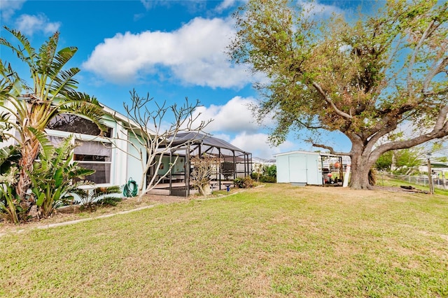 view of yard with a shed, glass enclosure, and a patio