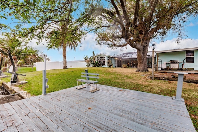 wooden deck with glass enclosure and a yard