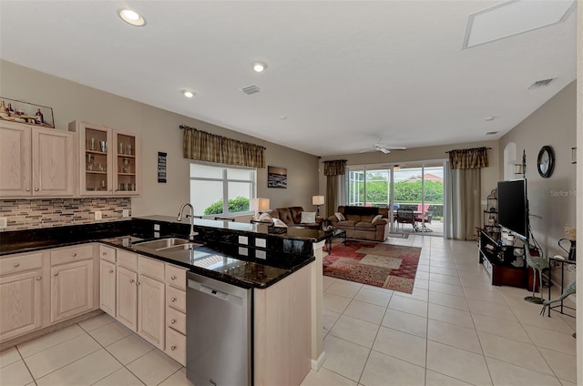 kitchen featuring stainless steel dishwasher, kitchen peninsula, sink, and ceiling fan