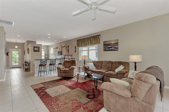 tiled living room with ceiling fan