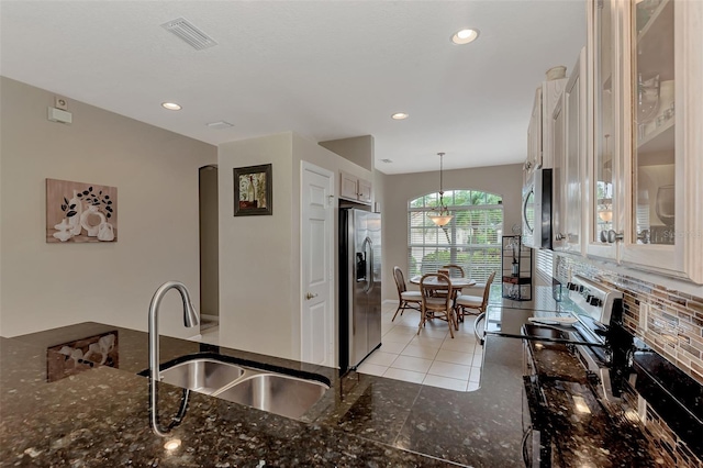 kitchen featuring white cabinets, sink, pendant lighting, and appliances with stainless steel finishes