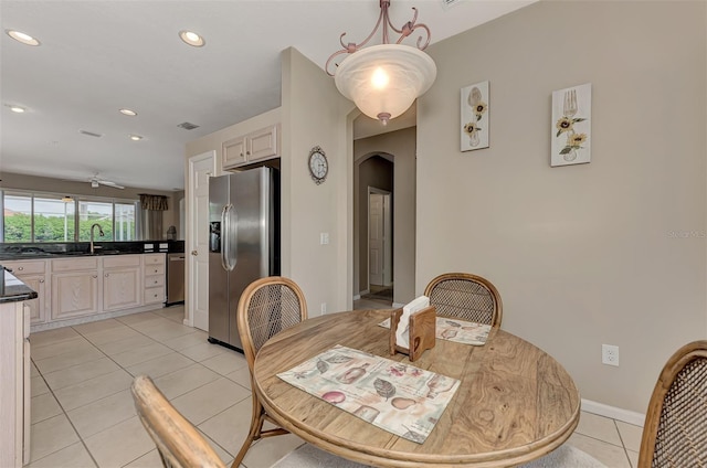 tiled dining room with sink and ceiling fan