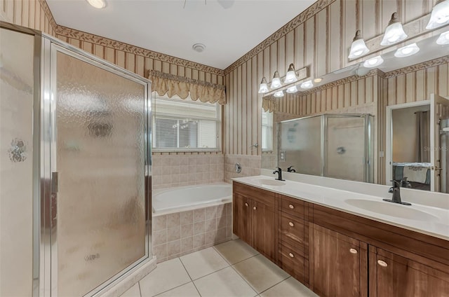 bathroom with independent shower and bath, vanity, and tile patterned floors