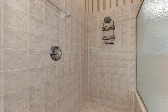 bathroom with a tile shower