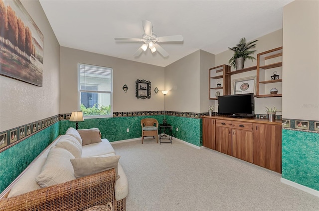 carpeted living room with ceiling fan