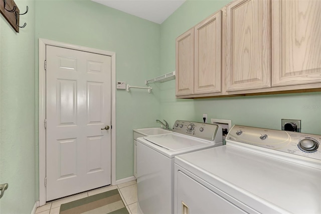 washroom with light tile patterned floors, cabinets, sink, and washer and dryer