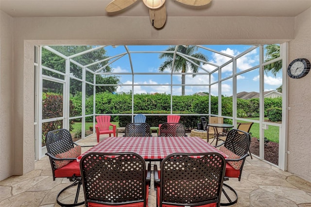 view of patio featuring ceiling fan and a lanai