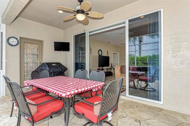 view of patio with area for grilling and ceiling fan