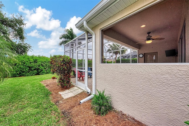 exterior space featuring a lanai and ceiling fan