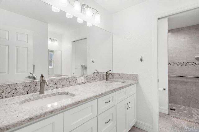 bathroom featuring vanity and a tile shower