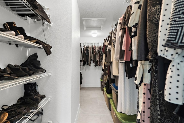 spacious closet featuring light tile patterned floors