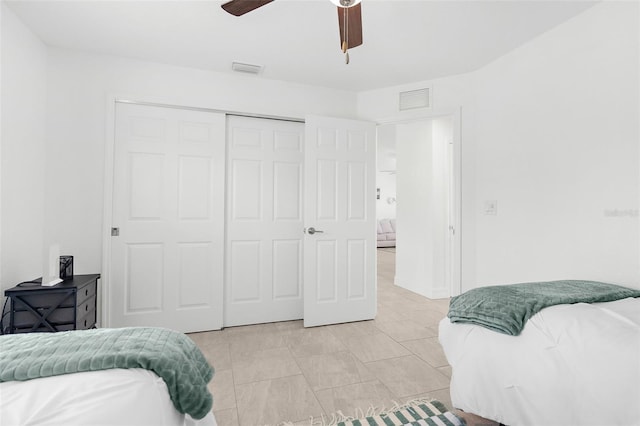 tiled bedroom featuring a closet and ceiling fan