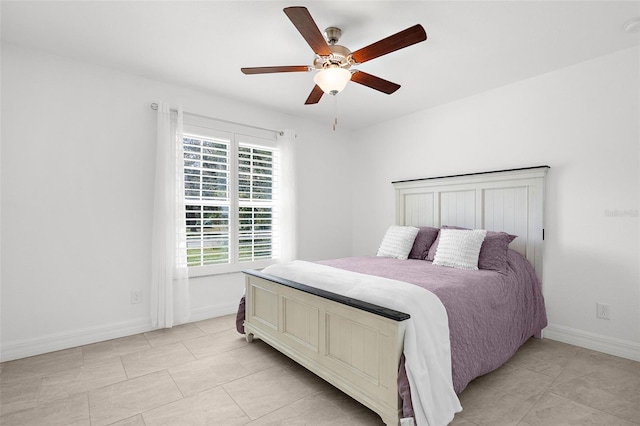 tiled bedroom featuring ceiling fan