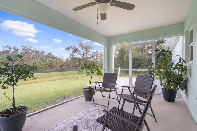 sunroom featuring ceiling fan