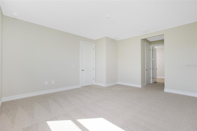 unfurnished room with light carpet