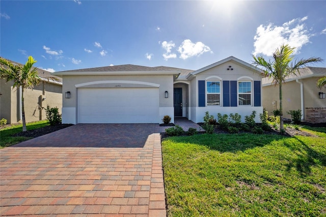 ranch-style house with a garage and a front yard