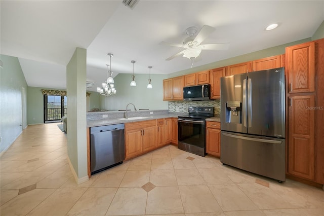 kitchen with light tile patterned flooring, backsplash, appliances with stainless steel finishes, decorative light fixtures, and sink