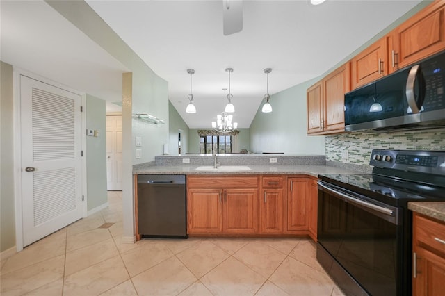 kitchen with lofted ceiling, black appliances, sink, light tile patterned floors, and pendant lighting