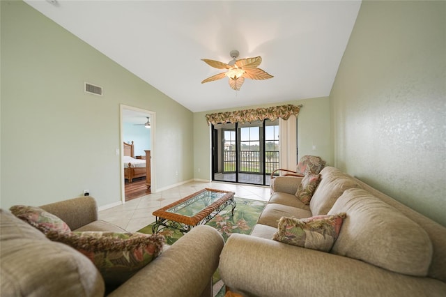 living room with ceiling fan, vaulted ceiling, and light tile patterned flooring