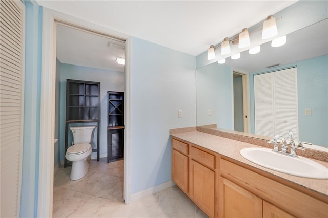 bathroom with vanity and toilet