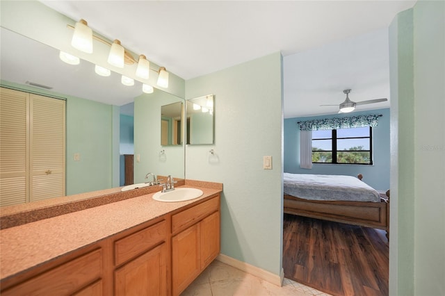 bathroom featuring hardwood / wood-style floors, vanity, and ceiling fan