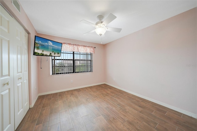 empty room featuring hardwood / wood-style flooring and ceiling fan