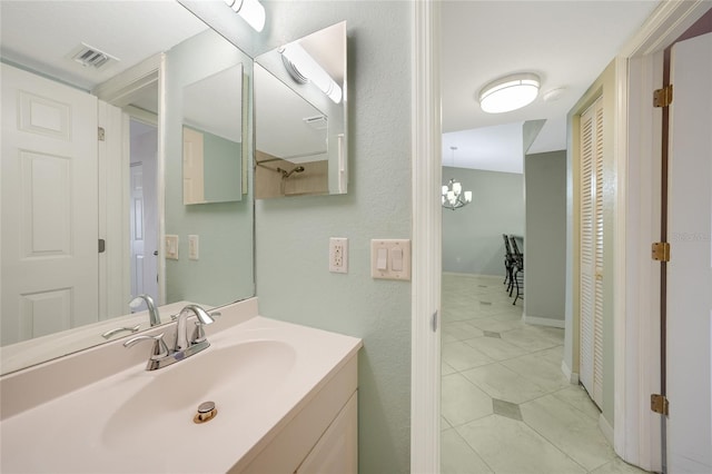 bathroom featuring vanity and a notable chandelier