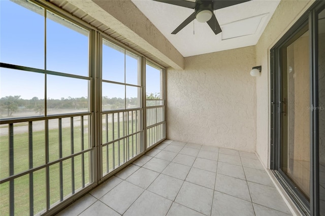 unfurnished sunroom with ceiling fan