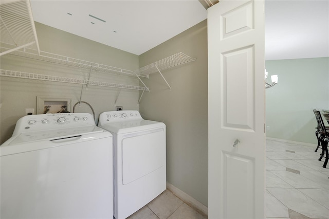 laundry area with light tile patterned floors and independent washer and dryer