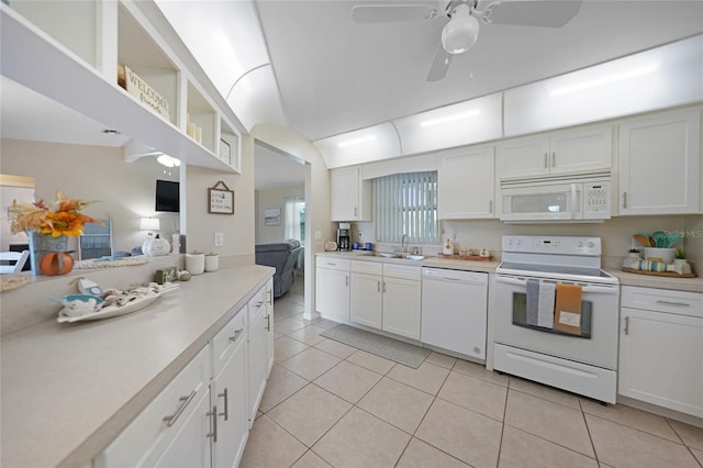 kitchen featuring white cabinetry, light tile patterned flooring, and white appliances