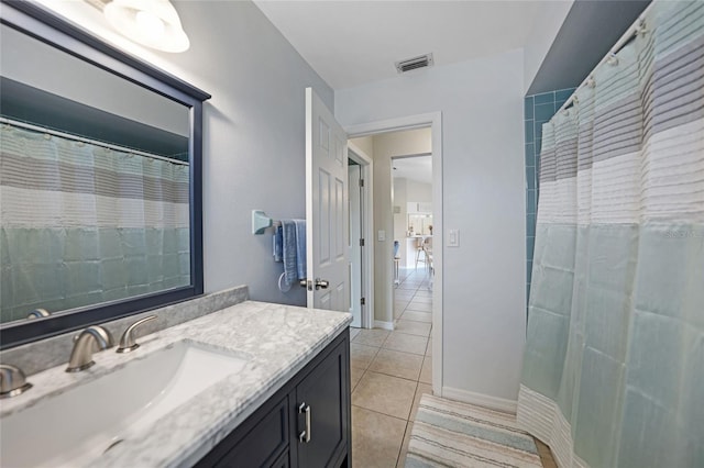 bathroom featuring vanity, walk in shower, and tile patterned floors