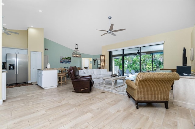 living room featuring light hardwood / wood-style floors, ceiling fan, and high vaulted ceiling