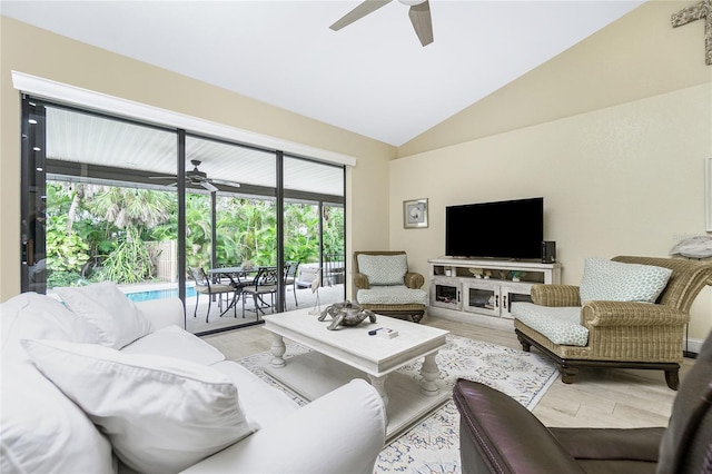 living room with plenty of natural light, lofted ceiling, ceiling fan, and light hardwood / wood-style flooring