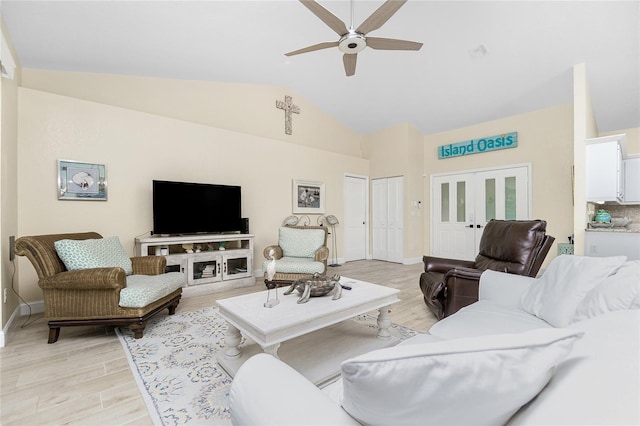 living room with light hardwood / wood-style floors, ceiling fan, and vaulted ceiling