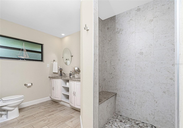 bathroom with toilet, vanity, and hardwood / wood-style flooring