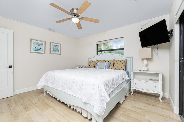 bedroom with ceiling fan and light hardwood / wood-style flooring