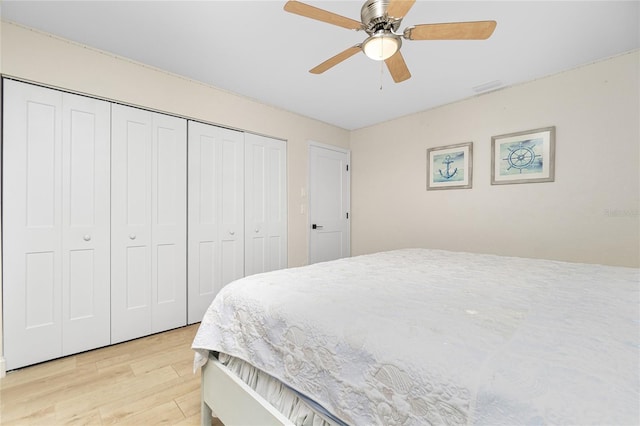 bedroom with light hardwood / wood-style floors and ceiling fan