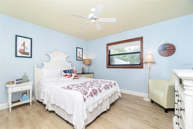 bedroom with light hardwood / wood-style floors and ceiling fan